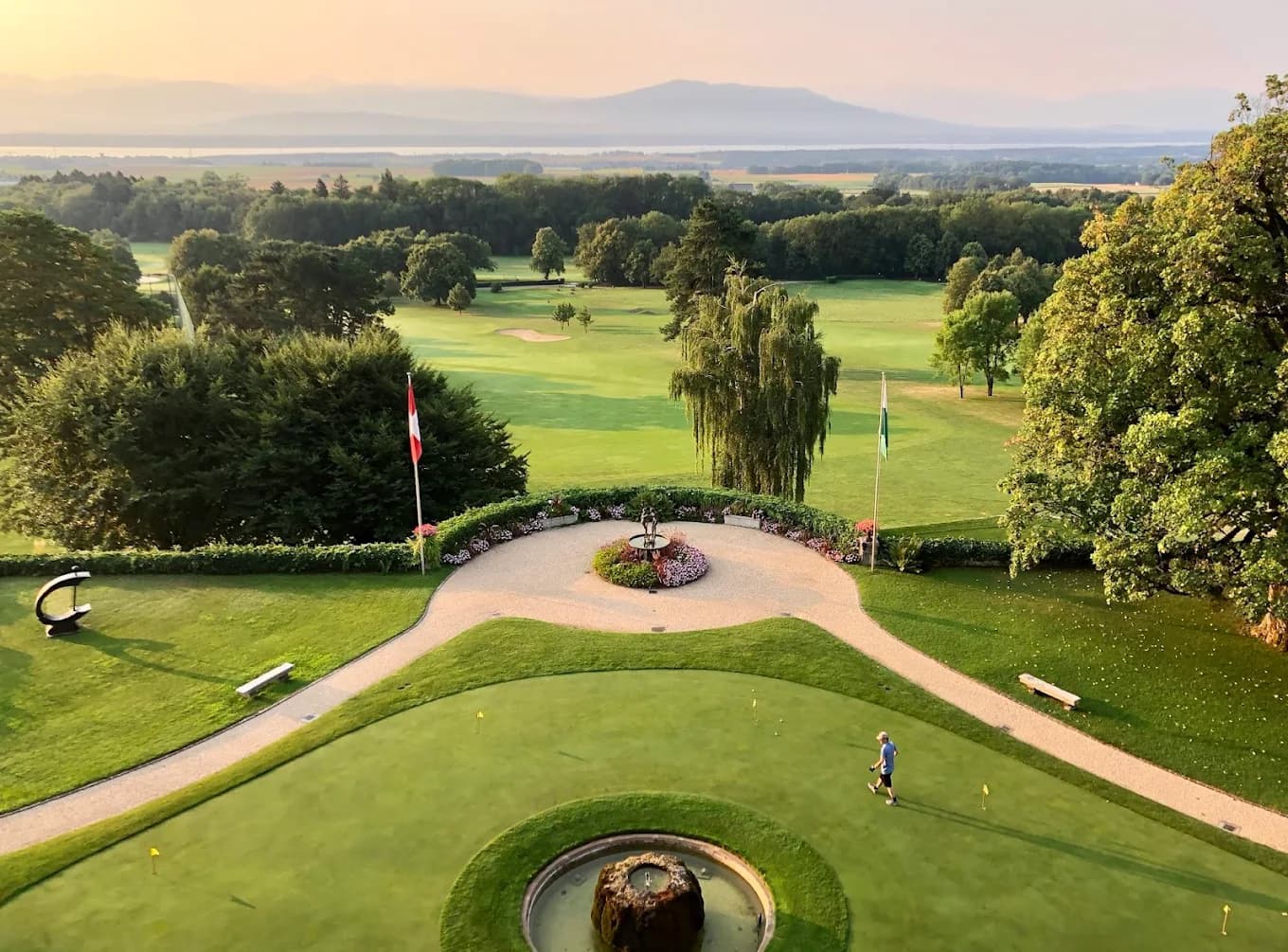 Bonmont golf course with Swiss flag and Alps